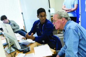 A Trinity College student assisting the community with accounting skills