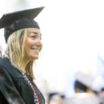 A smiling Trinity College graduate